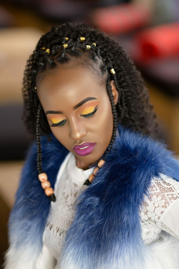 Portrait of young woman with braids closing her eyes Portrait of young woman with braids closing her eyes